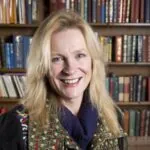 ILS Case Manager Elaine Cook, a blonde-haired woman in a jacket, stands before bookshelves, is based in Calne, Wiltshire.