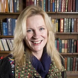 ILS Case Manager Elaine Cook, a blonde-haired woman in a jacket, stands before bookshelves, is based in Calne, Wiltshire.
