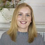 ILS Case Manager Imelda Molloy, a woman with blonde hair and blue eyes, smiles warmly. She is based in St Albans, Hertfordshire.
