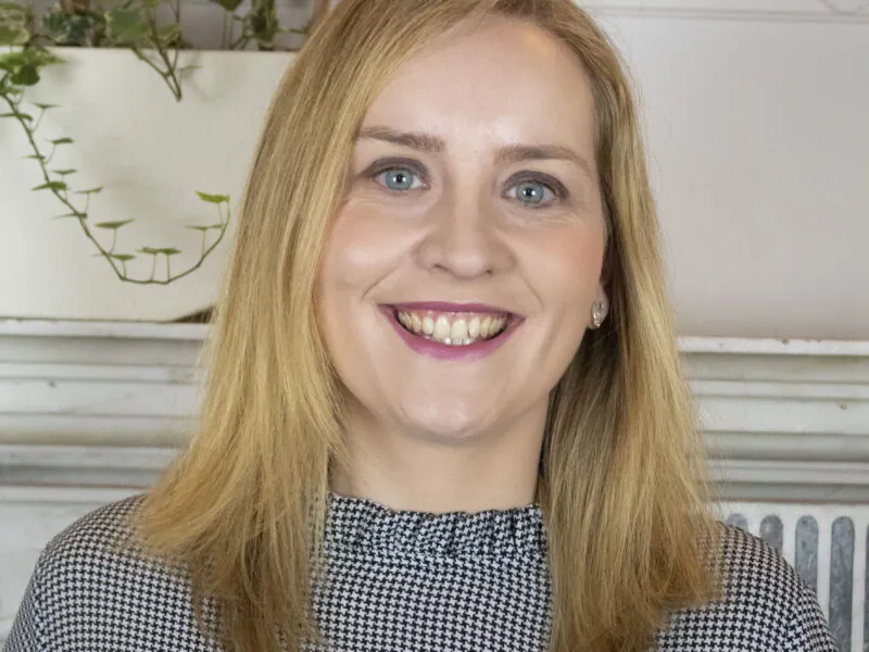 ILS Case Manager Imelda Molloy, a woman with blonde hair and blue eyes, smiles warmly. She is based in St Albans, Hertfordshire.