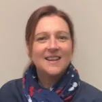 Louise Ainger, an ILS Case Manager based in Hereford, Herefordshire, is wearing a blue and red scarf and a blue top.