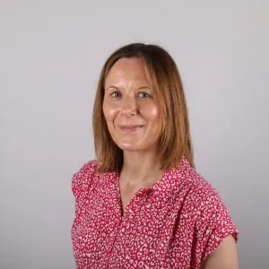 Shona Fashipe, an ILS Case Manager from Bath, Somerset, dressed in a dark pink patterned blouse.