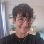 Based in Maidenhead, Berkshire, ILS Case Manager Ellen Selvey is a woman with glasses and a black shirt. She smiles warmly at the camera.